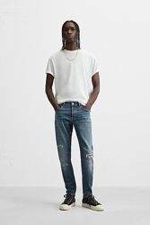 Джинсы с разрывами и эффектом брызг краски